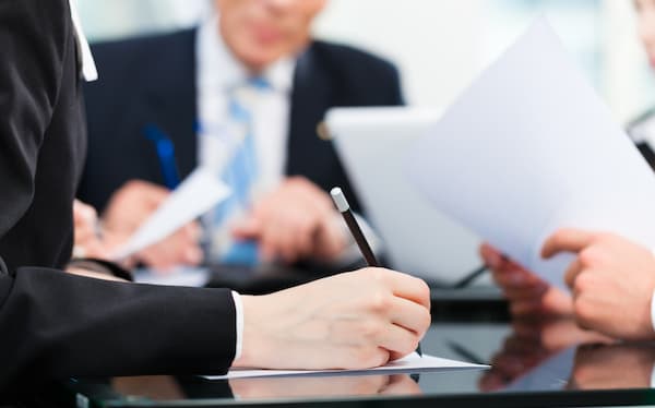 a woman is sitting at a table discussing tax planning