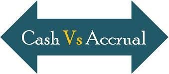 a green sign with two arrows pointing in opposite directions that says Cash vs. Accrual