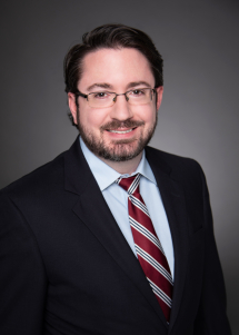 professional headshot of Greg Logan, CPA, CITP wearing glasses and a suit and tie