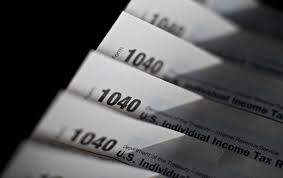 a close up of a stack of 1040 income tax forms