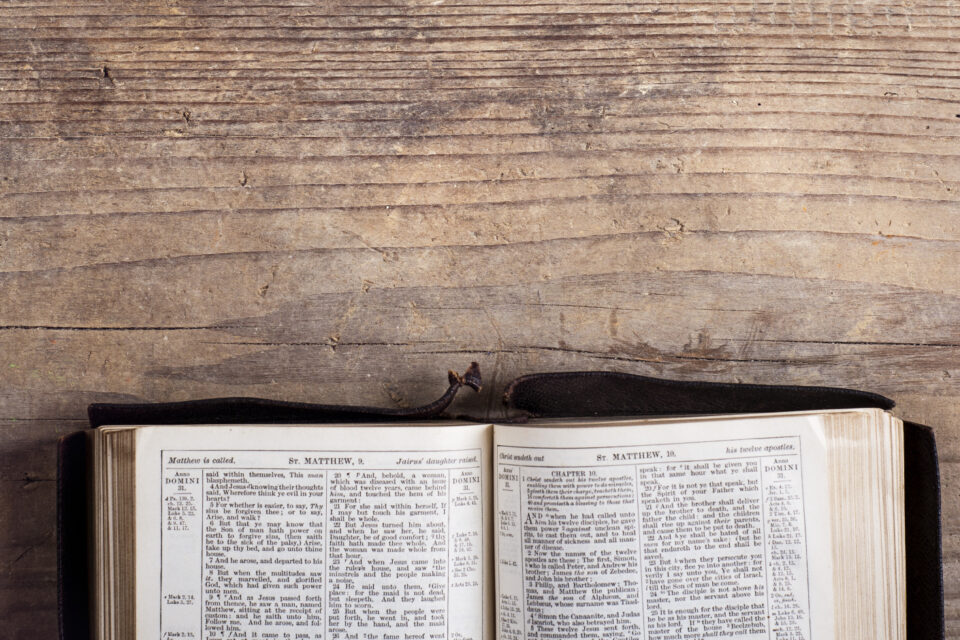 a bible on a wood table open to the book of psalms