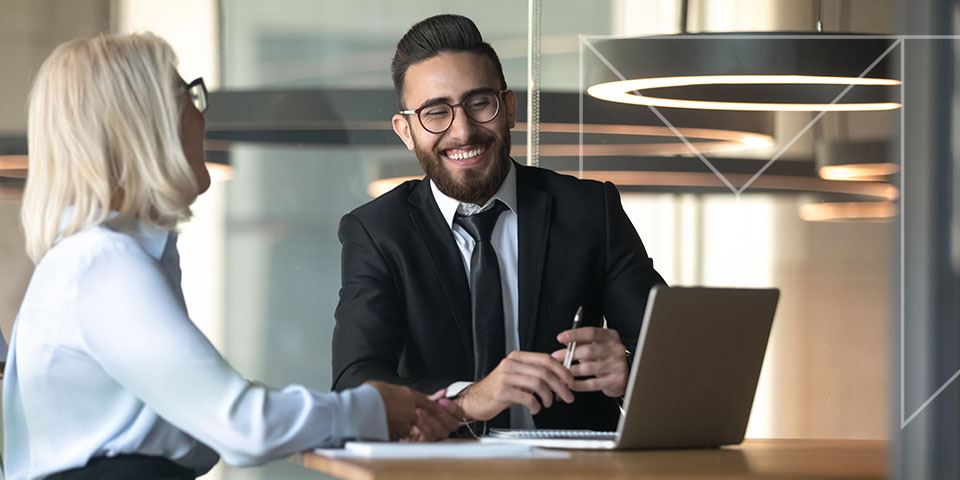 man and woman laughing in a financial meeting