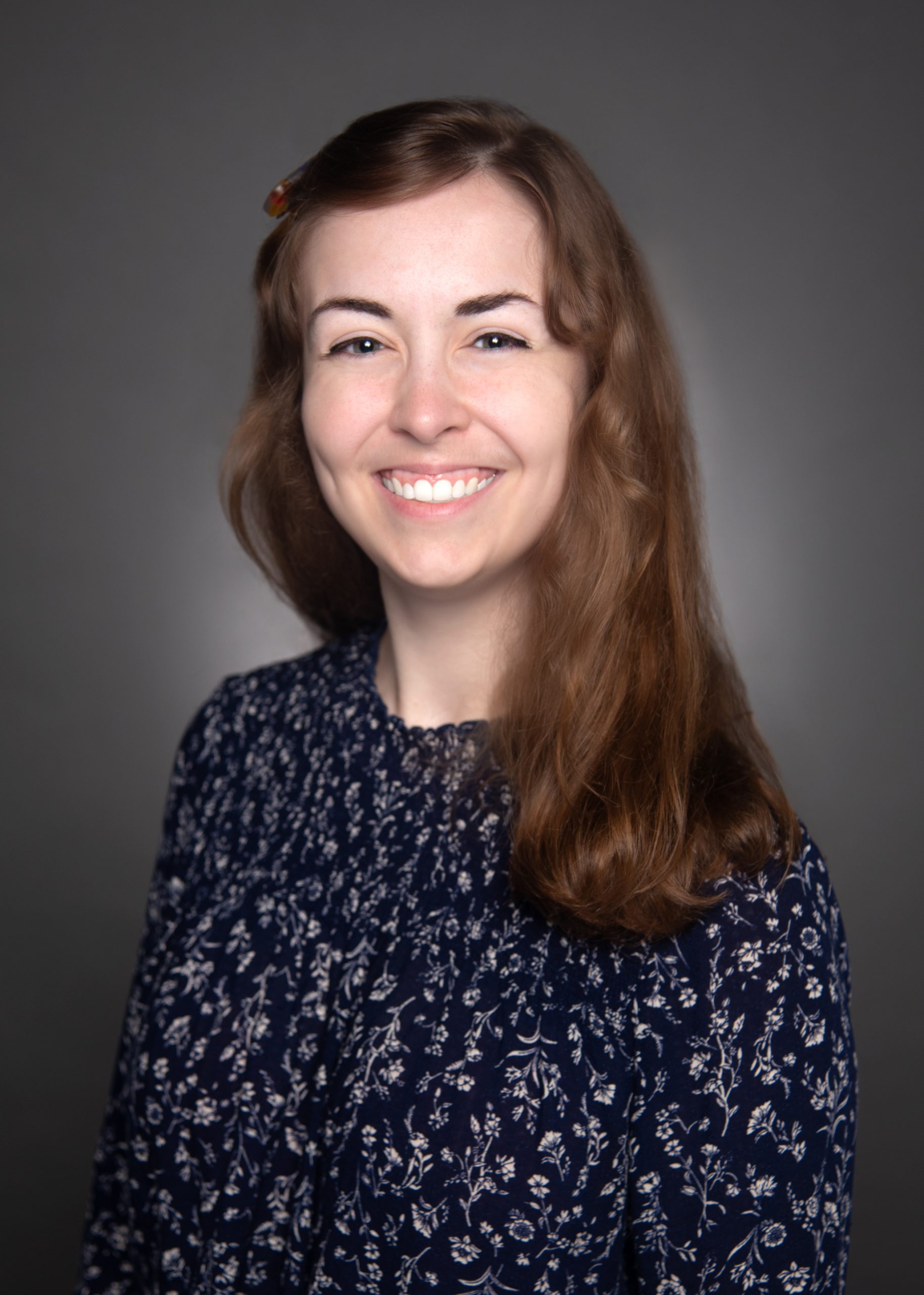 professional headshot of Claire Segura, Audit Associate, wearing a floral blouse
