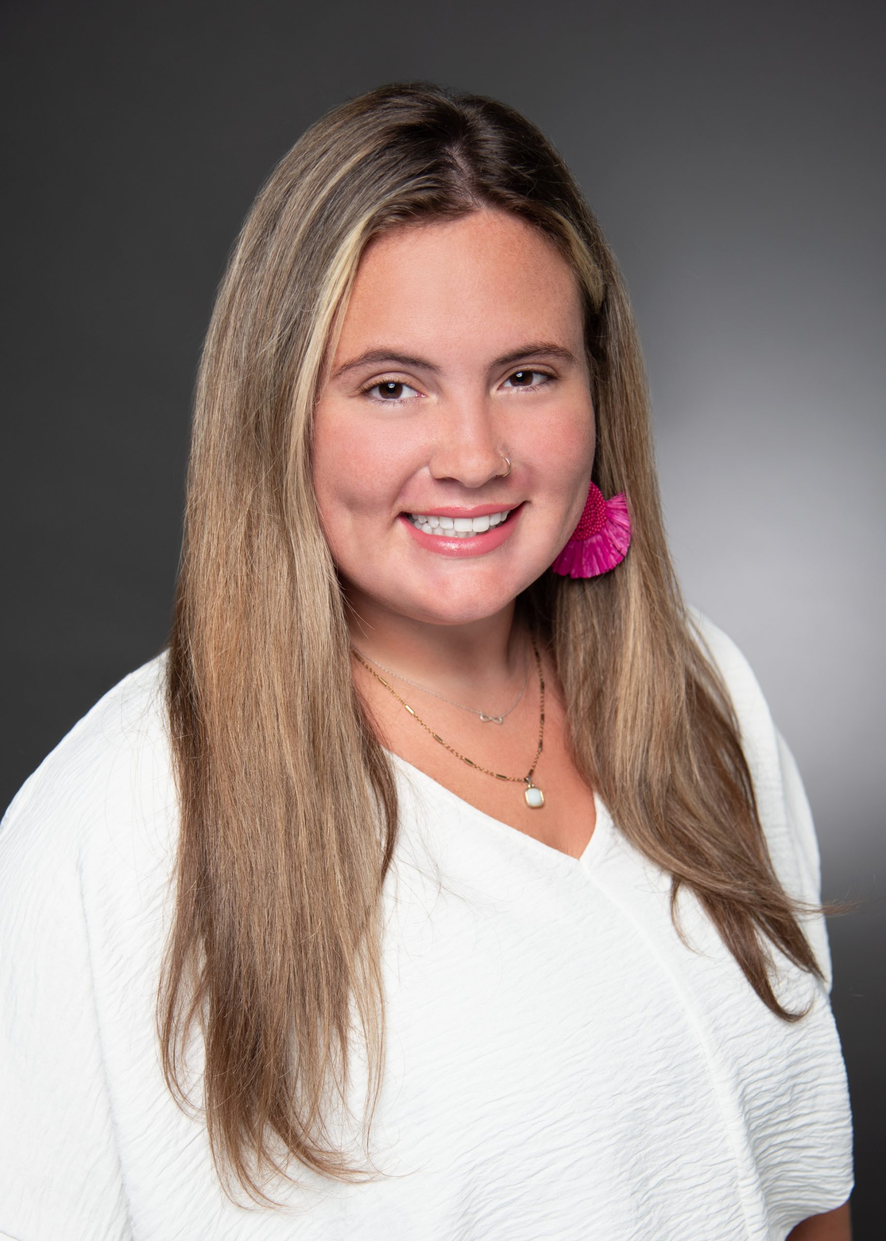 professional headshot of Mallory Howard, Audit Senior, wearing a white blouse and pink earrings