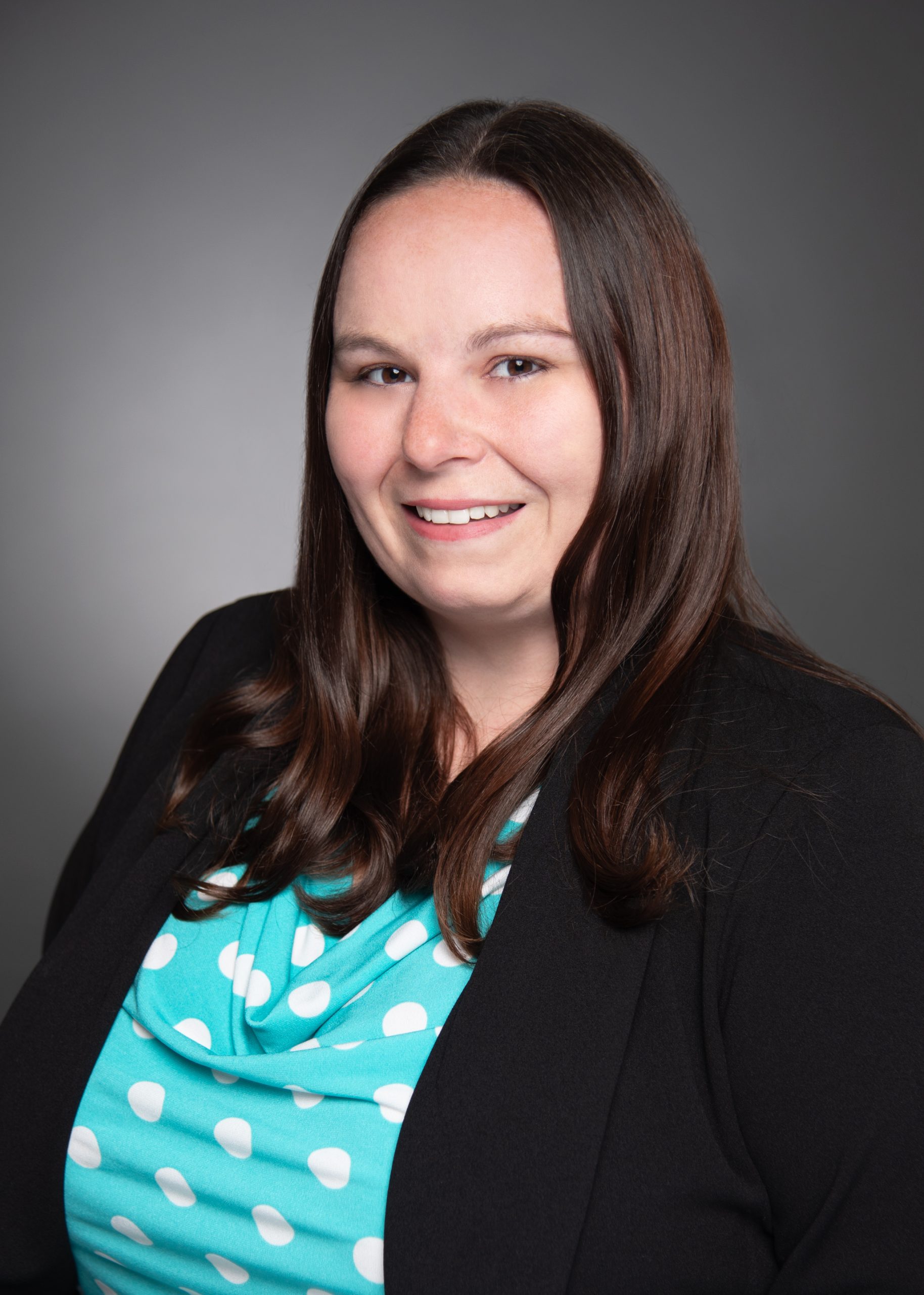 professional headshot of Stephanie Lowry, Accounting Associate, wearing a polka dot blouse and blazer
